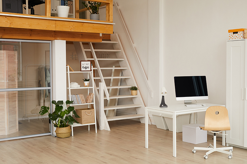 Background image of contemporary two level apartment interior with home office workplace in foreground.